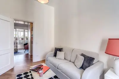 a living room with a couch and a table at Porta maggiore 2 bedroom with terrace in Rome