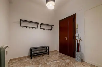 a room with a door and a bench on a wall at GuestHost - Trastevere Apartment Roma Portuense in Rome