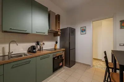 a kitchen with a sink and a refrigerator at GuestHost - Trastevere Apartment Roma Portuense in Rome
