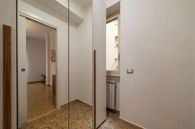 a room with a glass door and a hallway at GuestHost - Trastevere Apartment Roma Portuense in Rome