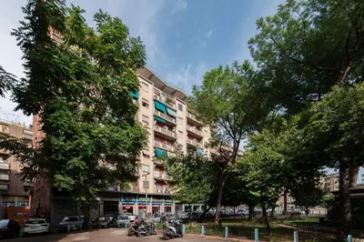 a tall apartment building with motorcycles parked in front of it at GuestHost - Trastevere Apartment Roma Portuense in Rome