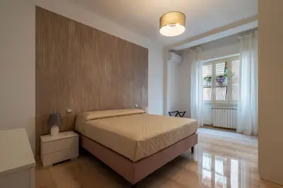 a bedroom with a large bed and a window at GuestHost - Trastevere Apartment Roma Portuense in Rome