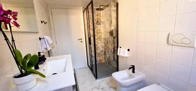 a bathroom with a shower and a sink and a toilet at Aurelio Vatican Holiday in Rome