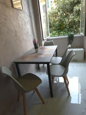 a table and chairs in a room with a window at Aurelio Vatican Holiday in Rome