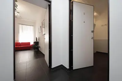 a door leading to a living room with a red couch at Neo Urbis Art Aparts in Rome