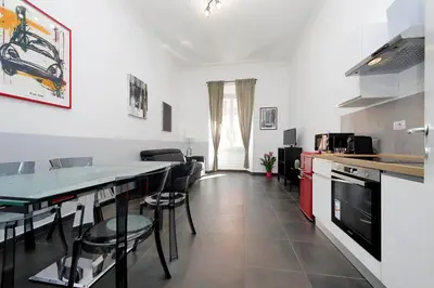 a kitchen with a counter and some chairs in it at Neo Urbis Art Aparts in Rome