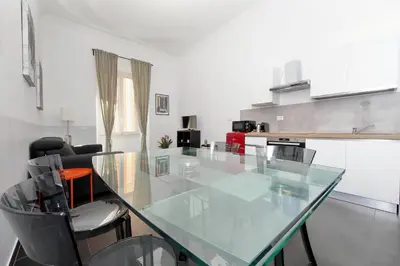 a kitchen with a glass table and some chairs at Neo Urbis Art Aparts in Rome