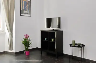 a tv sitting on a stand in a room at Neo Urbis Art Aparts in Rome