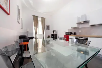 a dining room with a glass table and chairs at Neo Urbis Art Aparts in Rome