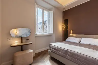 a bedroom with a bed and a lamp and a window at Porta Trastevere Palace in Rome