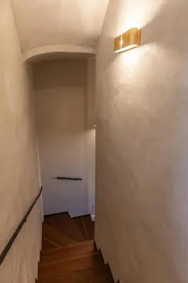 an empty hallway with a light on the wall at Porta Trastevere Palace in Rome