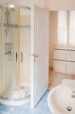 a bathroom with a shower and a tub and a sink at Cola di Rienzo Attico & Charme - by 101 Flats in Rome