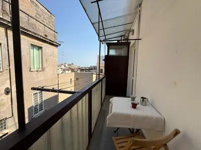 a balcony with a table and a view of a building at Casa di Mara by Valentina's Dream in Rome