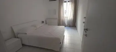 a white bedroom with a bed and a window at Alessandro's Home in Rome