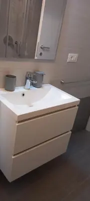 a bathroom with a white sink and a mirror at Alessandro's Home in Rome