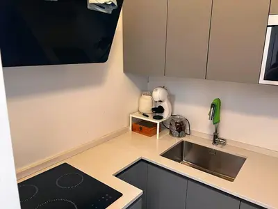 a small kitchen with a sink and a stove at Stay by the Pantheon in the Heart of Historic Rome in Rome