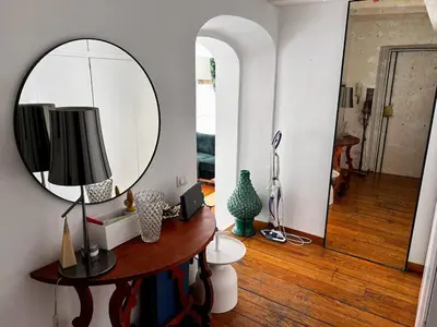 a room with a mirror and a table with a lamp at Stay by the Pantheon in the Heart of Historic Rome in Rome