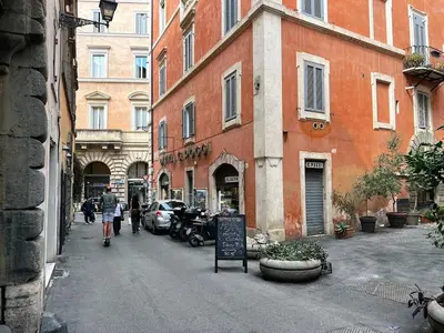 a street with buildings and people walking down the street at Stay by the Pantheon in the Heart of Historic Rome in Rome