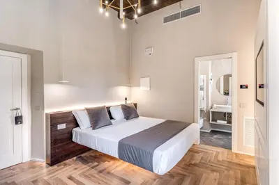 a bedroom with a large bed and a bathroom at AGH Pantheon in Rome