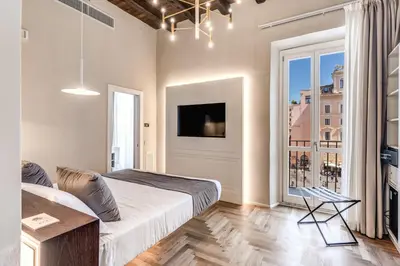 a bedroom with a bed and a large window at AGH Pantheon in Rome