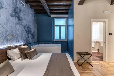 a bedroom with a large bed and a bath tub at AGH Pantheon in Rome