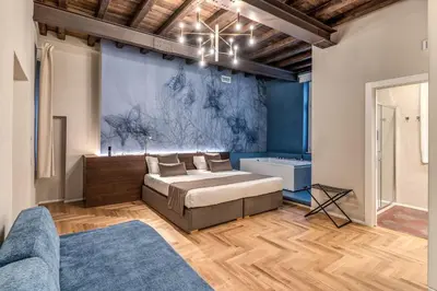 a bedroom with a bed and a blue wall at AGH Pantheon in Rome