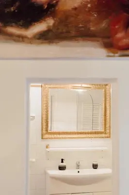 a bathroom with a mirror and a sink at The Oasis of Trastevere in Rome
