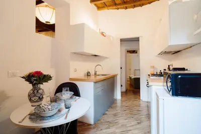 a kitchen with a small table and a sink at The Oasis of Trastevere in Rome