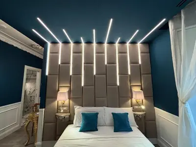 a bedroom with a large bed with lights above it at Lary's - San Pietro in Rome