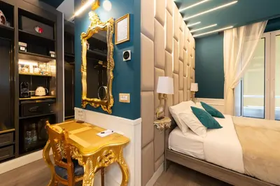 a bedroom with a bed with a mirror and a table at Lary's - San Pietro in Rome