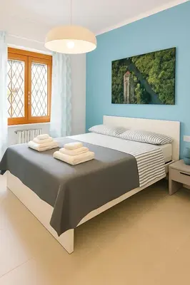 a bedroom with a large bed with towels on it at Casa Chanel in Rome