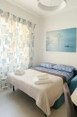 a bedroom with a bed with two towels on it at Casa Chanel in Rome