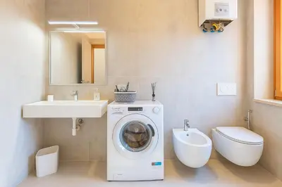 a bathroom with a washing machine and a sink at Casa Chanel in Rome
