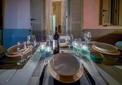 a table with glasses and a bottle of wine on it at Wine Stay, relaxation and style in Rome in Rome