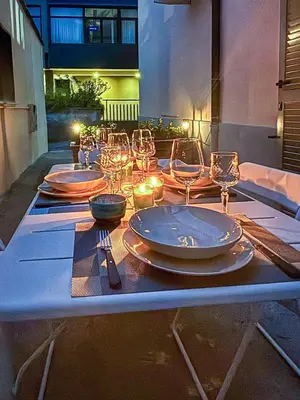 a table with plates and wine glasses on it at Wine Stay, relaxation and style in Rome in Rome