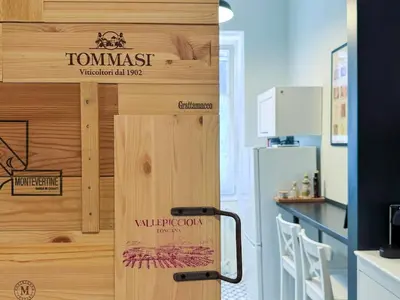 a wooden door with a sign that reads tummass dispensary at Wine Stay, relaxation and style in Rome in Rome