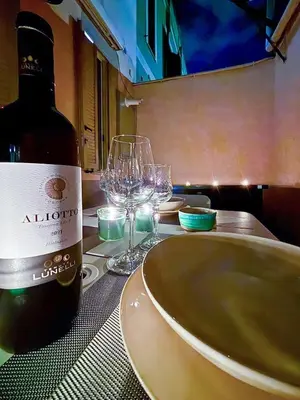 a bottle of wine sitting on a table with wine glasses at Wine Stay, relaxation and style in Rome in Rome