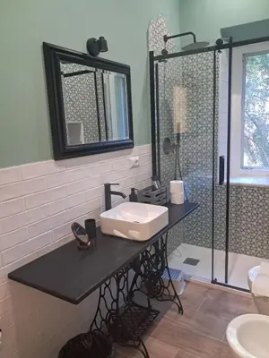 a bathroom with a sink and a shower at Trastevere St Rolli 15 in Rome