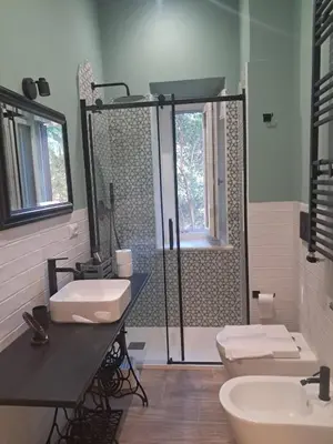 a bathroom with two sinks and a shower at Trastevere St Rolli 15 in Rome