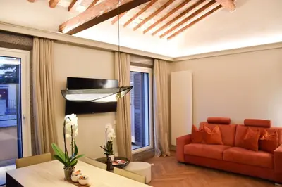 a living room with a red couch and a table at Spanish Steps - Luma Suite - Terraces & Rome View in Rome