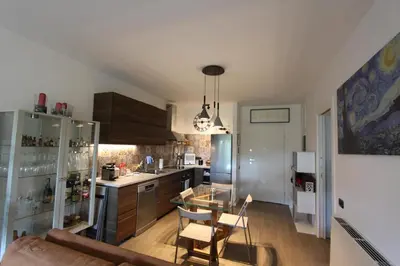 a kitchen with a table and chairs in a room at Clio Apartment in Rome