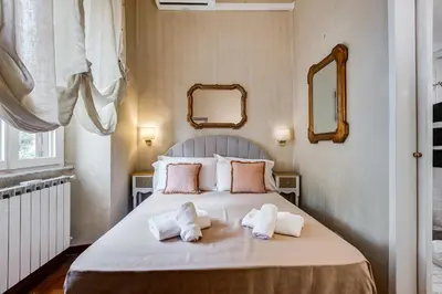 a bedroom with a bed with towels on it at Trastevere Liberty House in Rome