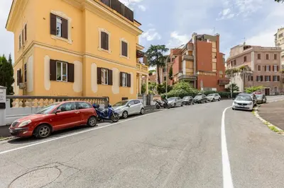 a row of cars parked on the side of a city street at Trastevere Liberty House in Rome