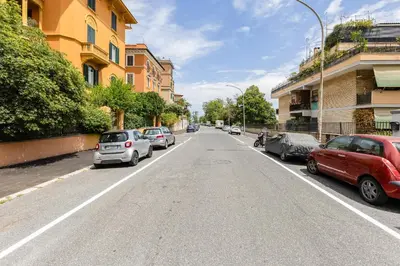 a street with cars parked on the side of the road at Trastevere Liberty House in Rome
