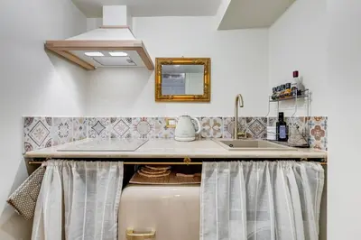 a kitchen with a sink and a counter top at Trastevere Liberty House in Rome