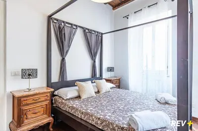 a bedroom with a bed with a dresser and a window at Banchi Nuovi Apartment in Rome