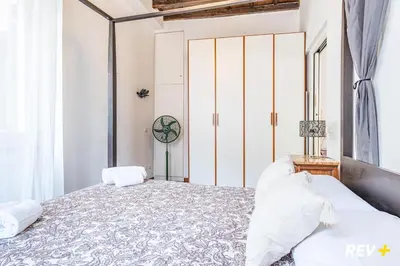 a bedroom with a bed and a clock on the wall at Banchi Nuovi Apartment in Rome