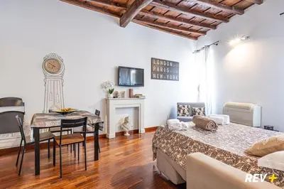 a room with a bed and a table and a dining room at Banchi Nuovi Apartment in Rome