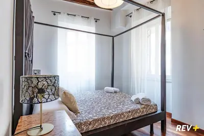 a bedroom with a canopy bed with a lamp at Banchi Nuovi Apartment in Rome