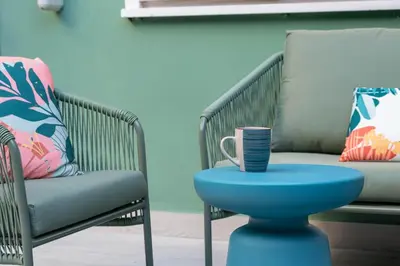 a blue table with a cup on it next to a chair at Vatican Museums Apartment with Romantic Terrace in Rome